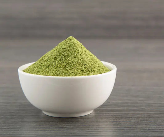 Broccoli sprout powder and fresh sprouts on a wooden surface representing health benefits