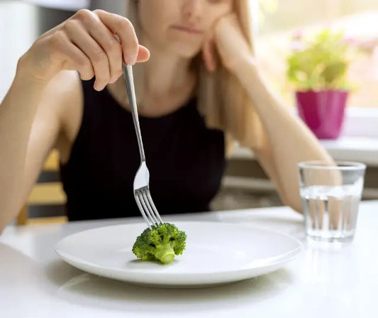 Broccoli sprout extract capsules with fresh broccoli sprouts on a clean background