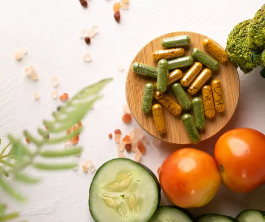 Three supplement bottles with broccoli sprouts, New Zealand blackcurrants and sliced green and gold kiwifruit on a breakfast bench